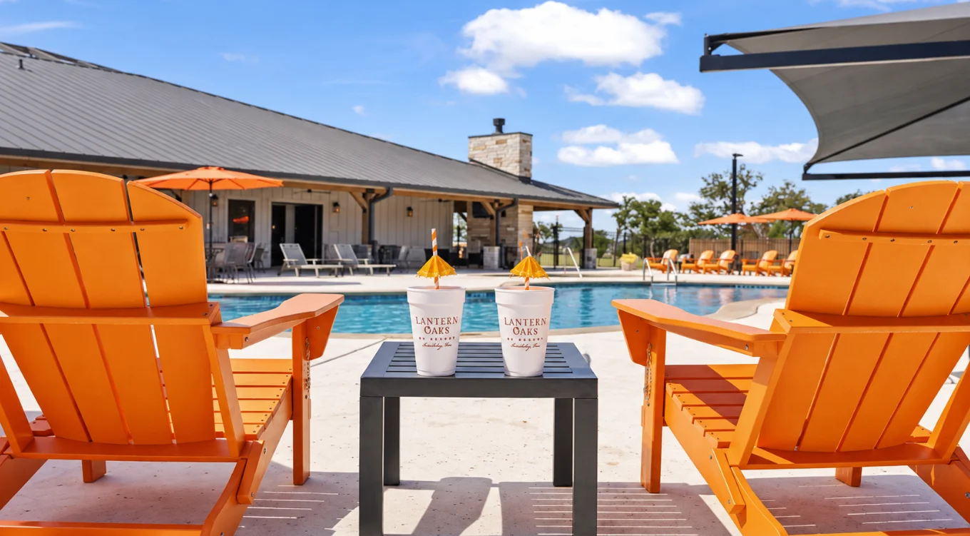 Orange Adirondack chairs by the pool