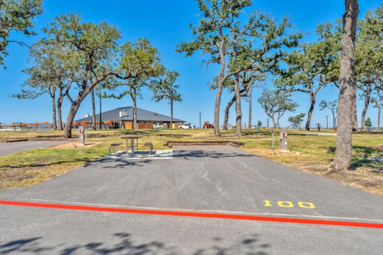Paved back-in RV site under oak trees