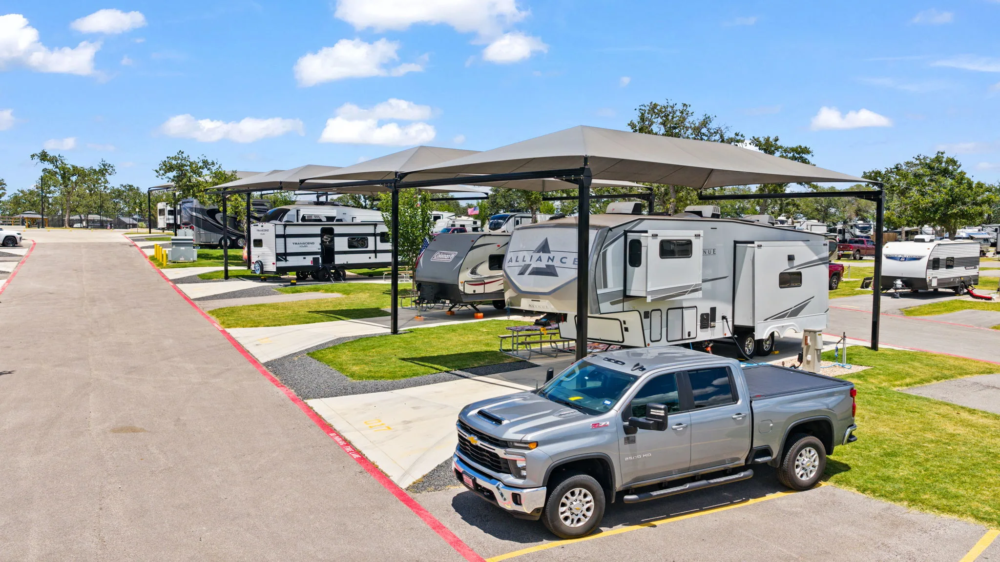 Pickup truck and travel trailer at a covered RV site