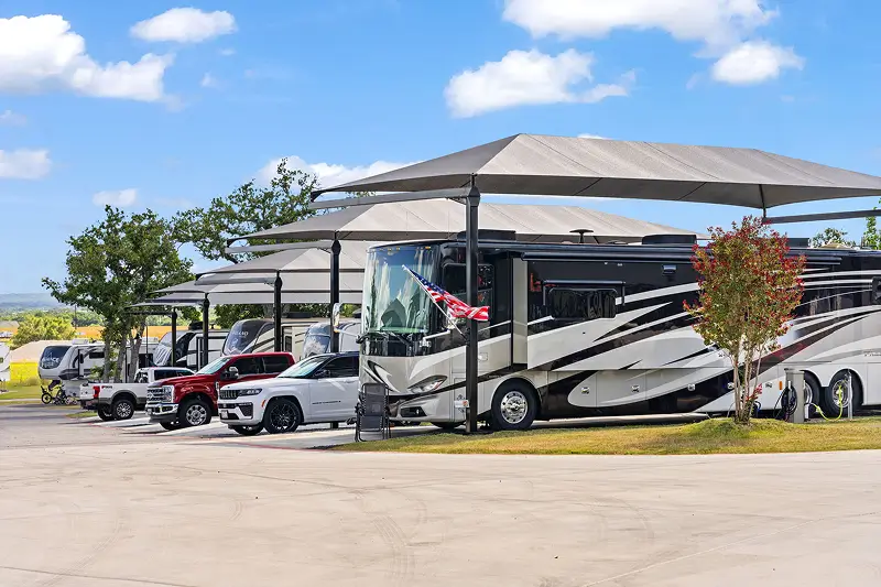 Motorcoaches parked at paved RV sites at Lantern Oaks RV Resort