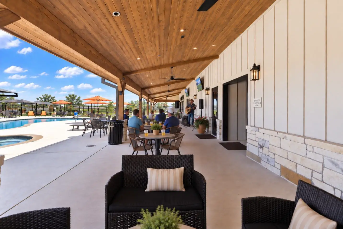 Covered patio with outdoor seating by the pool