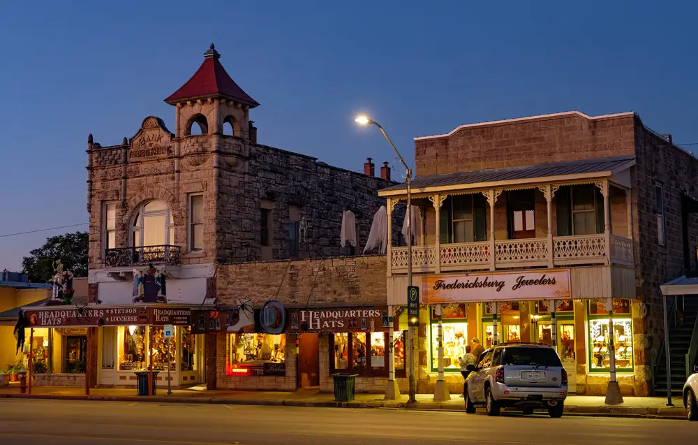 Historic Main Street storefronts in downtown Fredericksburg at dusk