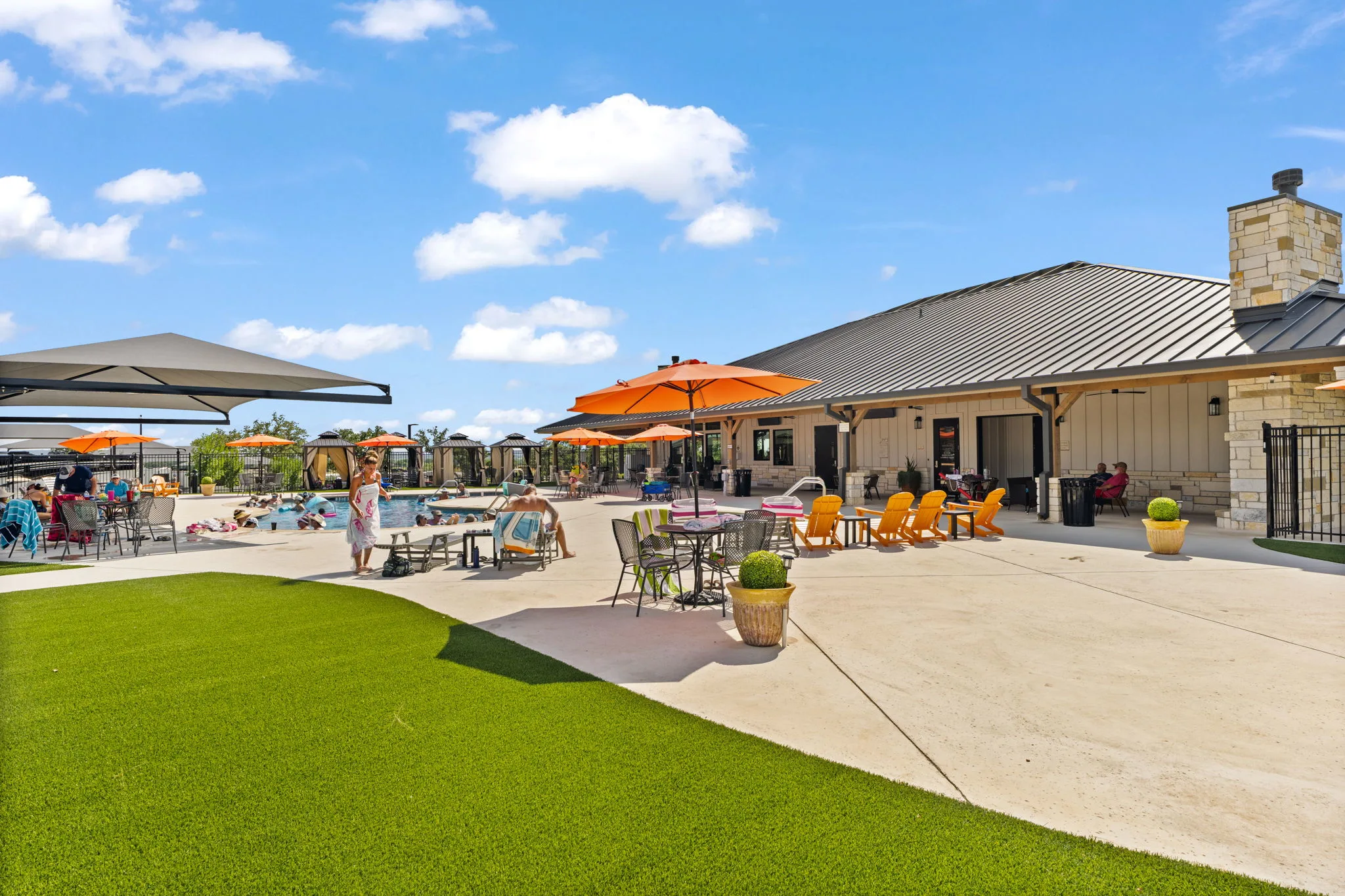 Pool deck with umbrellas next to the clubhouse