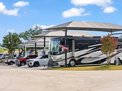 Motorcoaches parked at paved RV sites at Lantern Oaks RV Resort