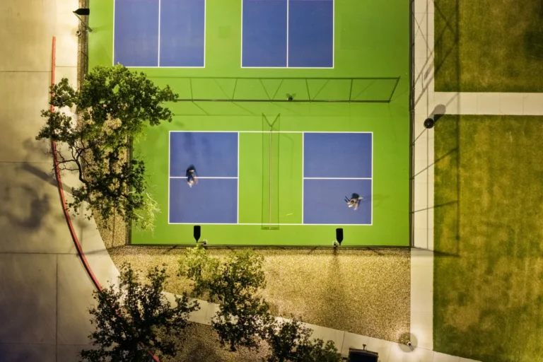 Players on the pickleball courts at Lantern Oaks at dusk, seen from above