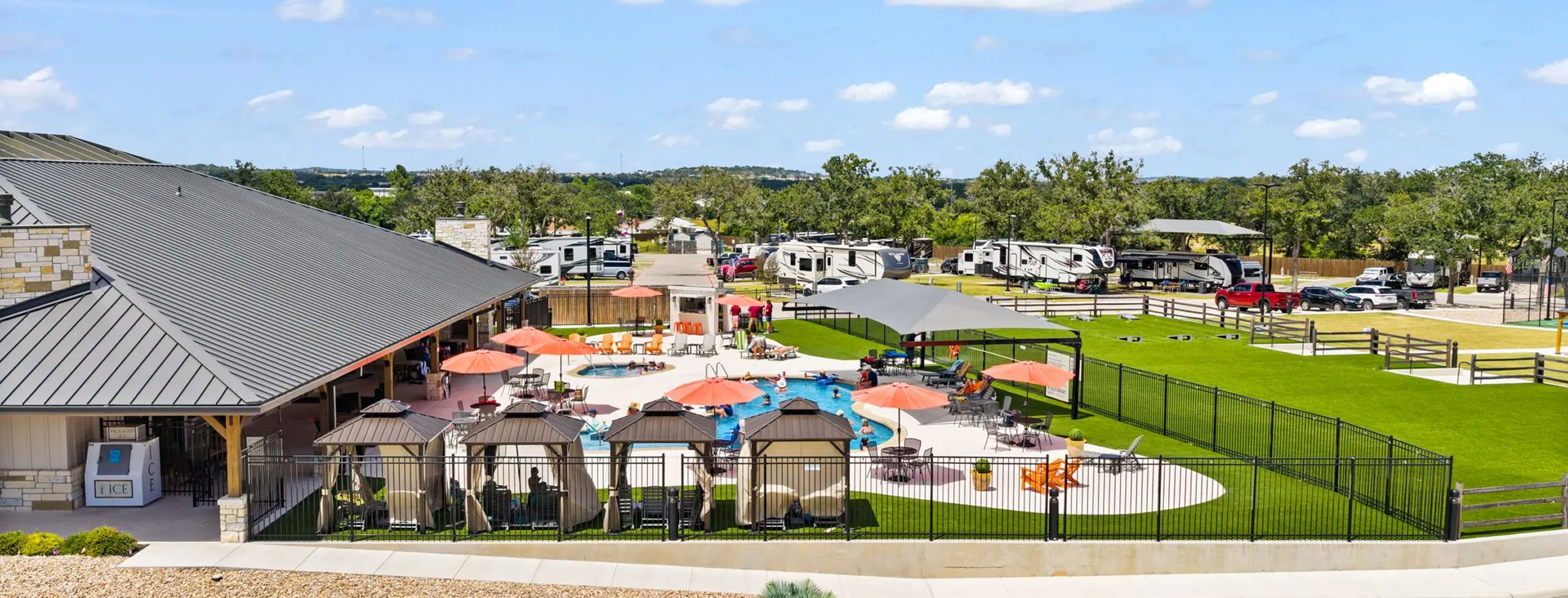 Aerial view of the clubhouse, pool and lawn at Lantern Oaks RV Resort