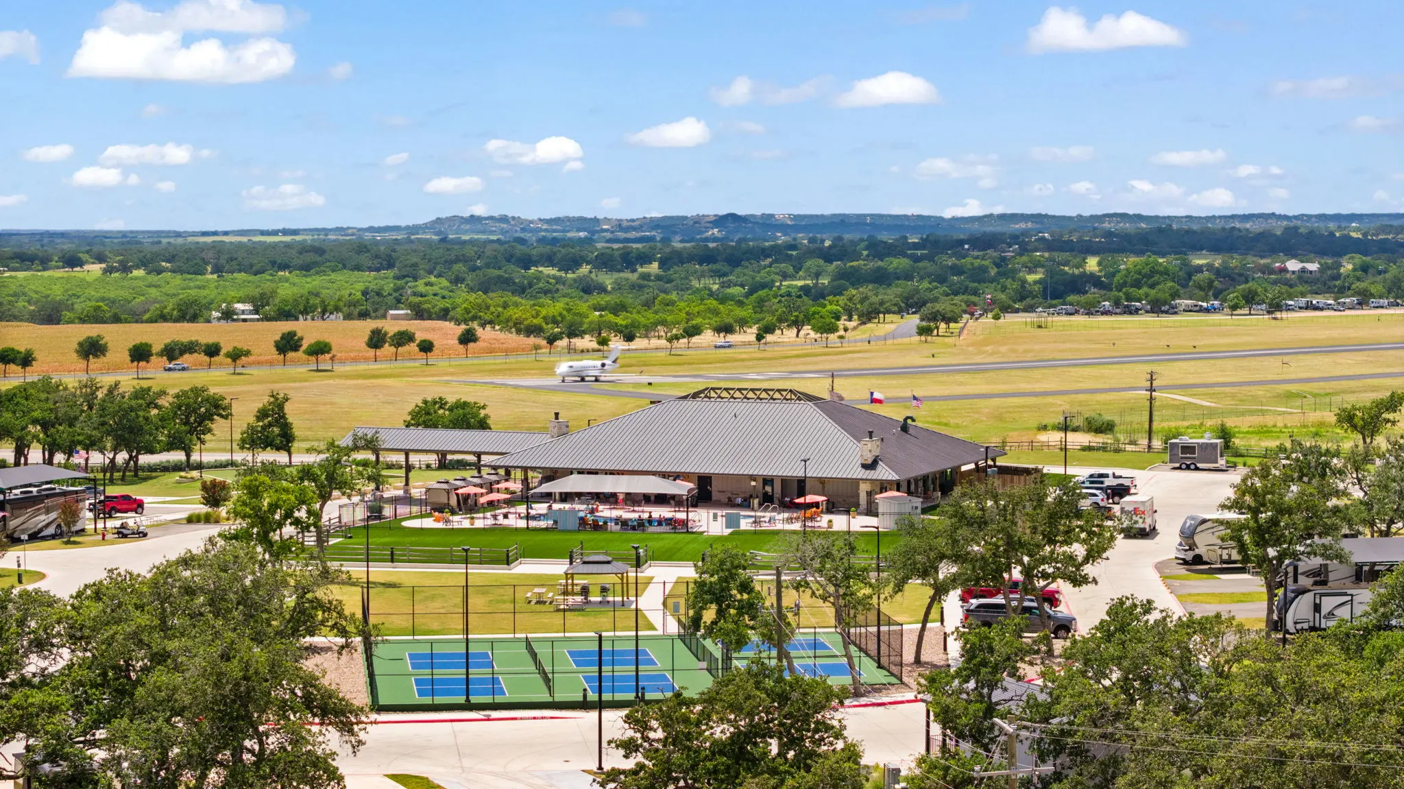 Aerial view of the pool, pickleball courts and resort grounds
